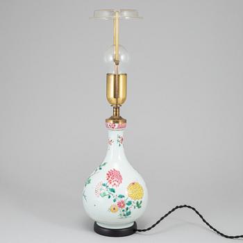 A famille rose bottle vase, Qing dynasty, 18th Century. Mounted as a lamp.