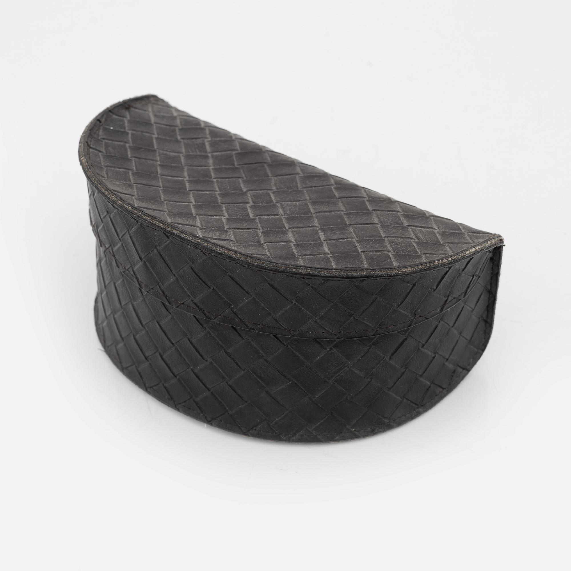 Bottega Veneta, a pair of sunglasses.