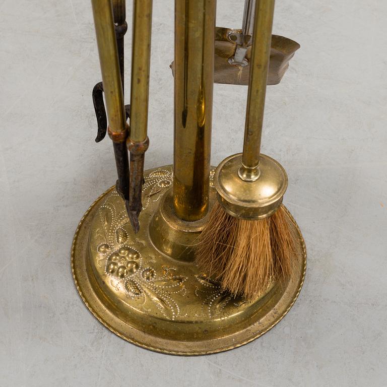 A set of 4 brass fire utensils with stand, 20th Century.