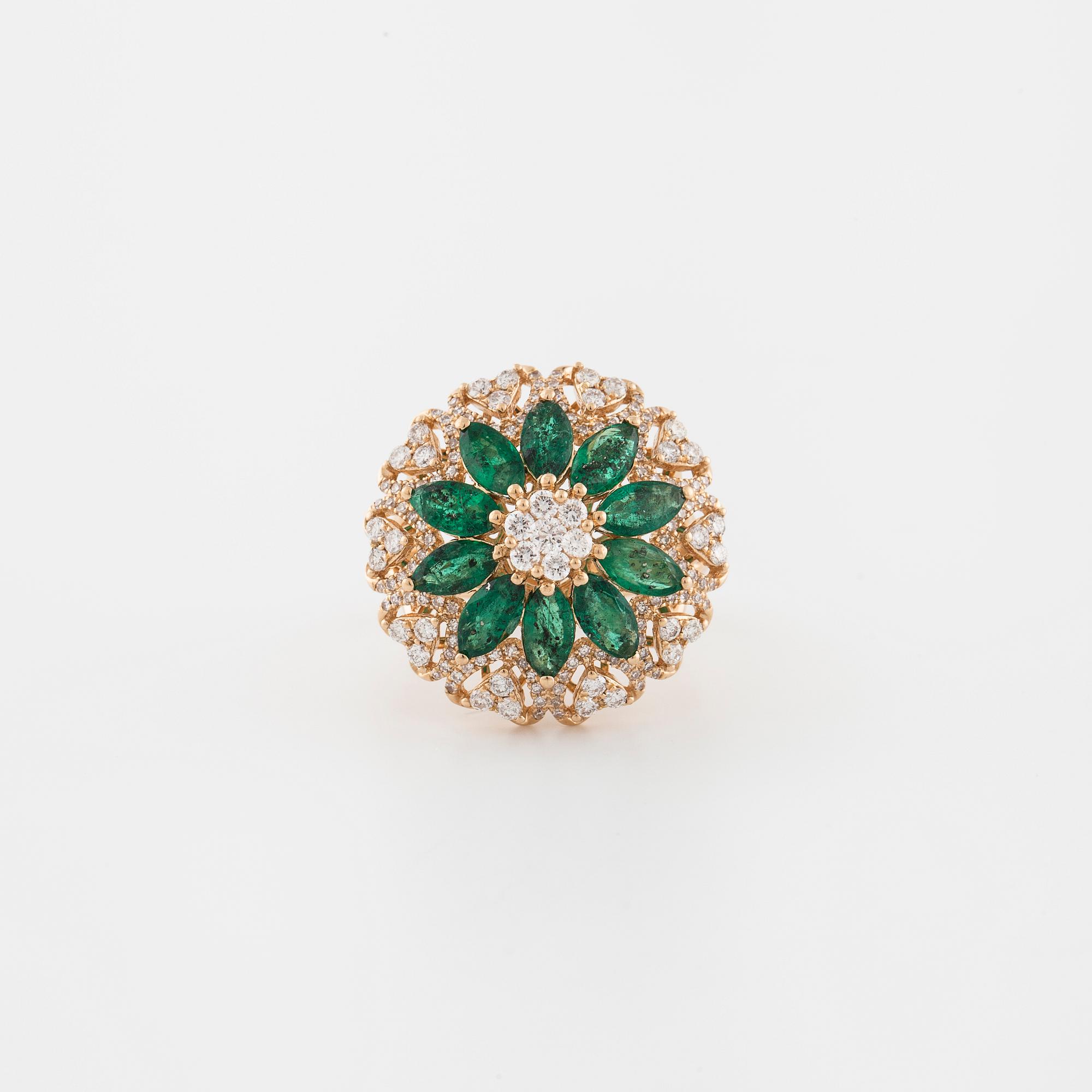 An marquise cut emerald and brilliant cut diamond ring.