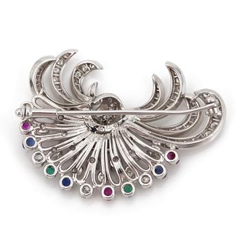 A brooch set with rubies, sapphires, emeralds and diamonds.