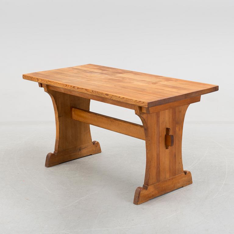 A solid pine table attributed to Axel Einar Hjort.
