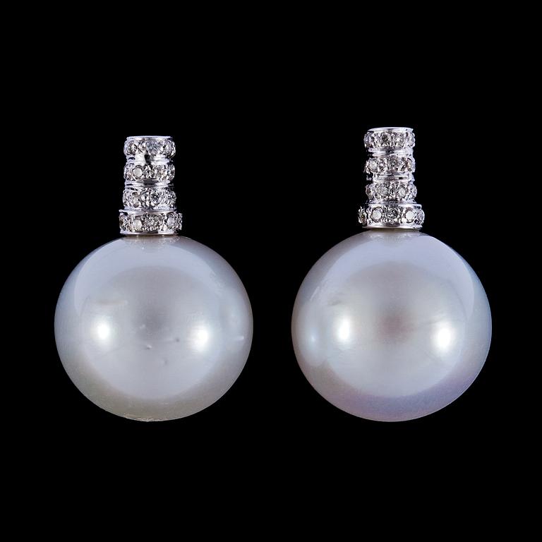A pair of cultured South sea pearl, 15,5 mm, and diamond earrings, tot. app. 0.35 cts.