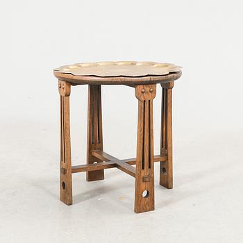 An oak and brass table first half of the 20th century.