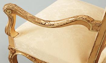 A pair of Régence-style circa 1900 armchairs.