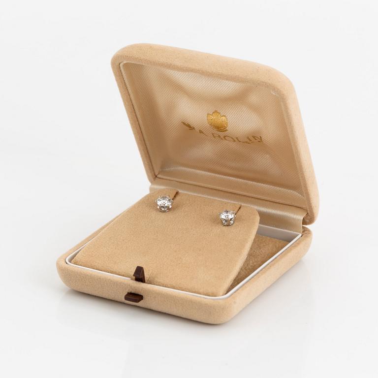 A pair of 18K white gold earrings set with two round brilliant-cut diamonds.