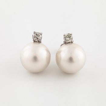 A pair of cultured pearl and old cut diamond earrings.