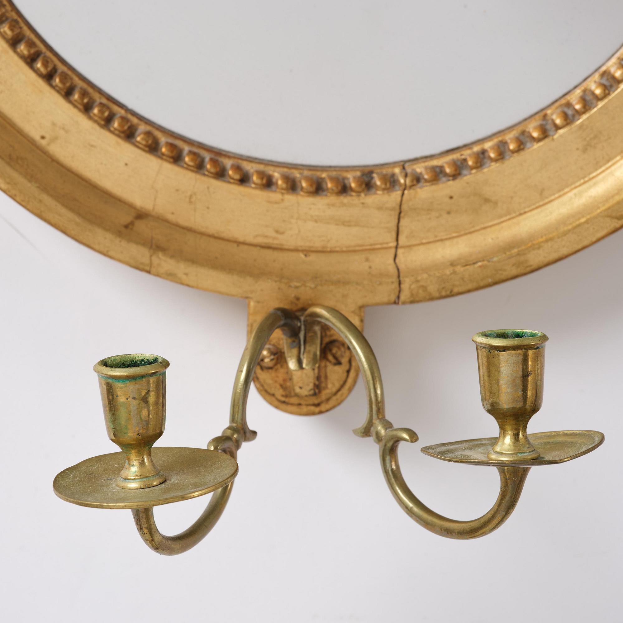 A pair of Gustavian giltwood two-branch girandole mirrors by J. Åkerblad (master in Stockholm 1758-99).