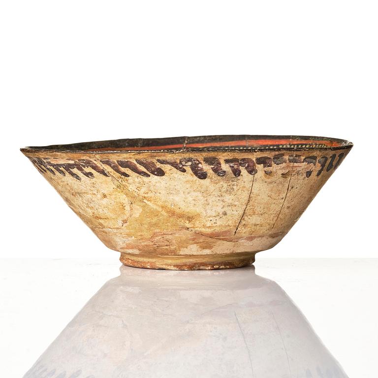 A conic pottery bowl, probably Nishapur, Northeast Persia, 10th century.