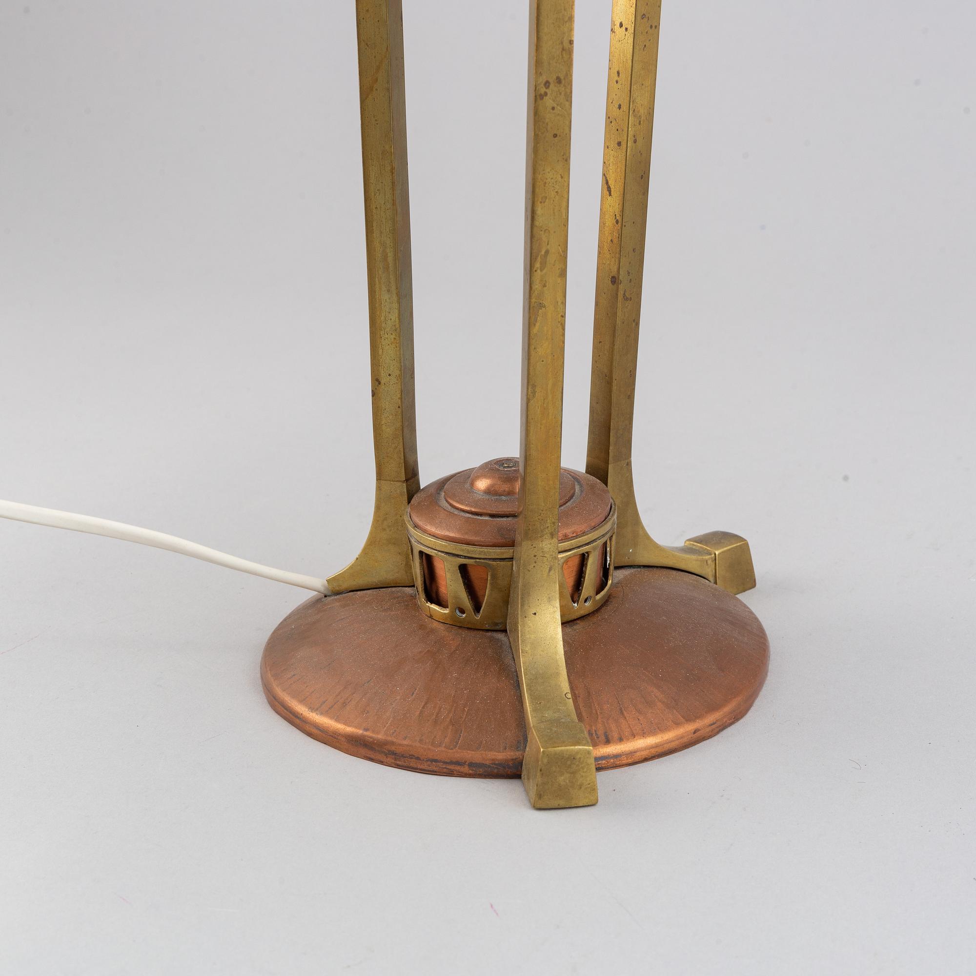 An early 20th century, brass and copper table lamp.