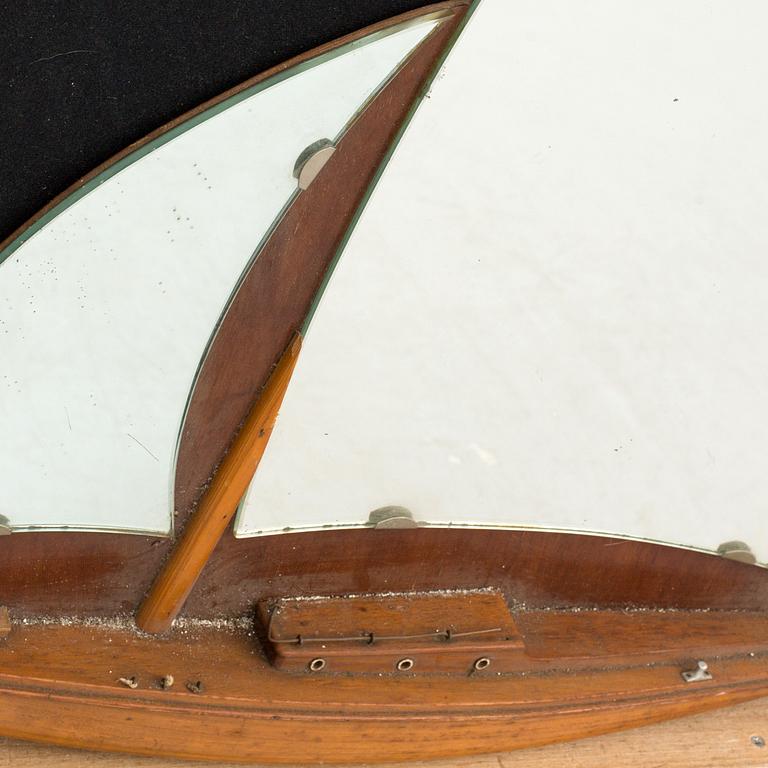 A BOAT SHAPED MIRROR, mid 20th century.