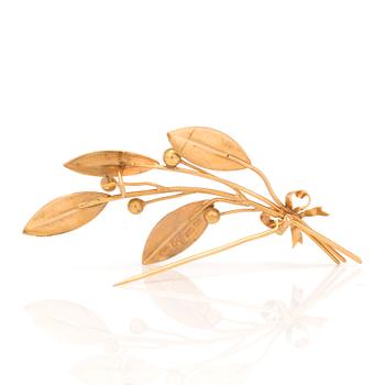 An 18K gold brooch.