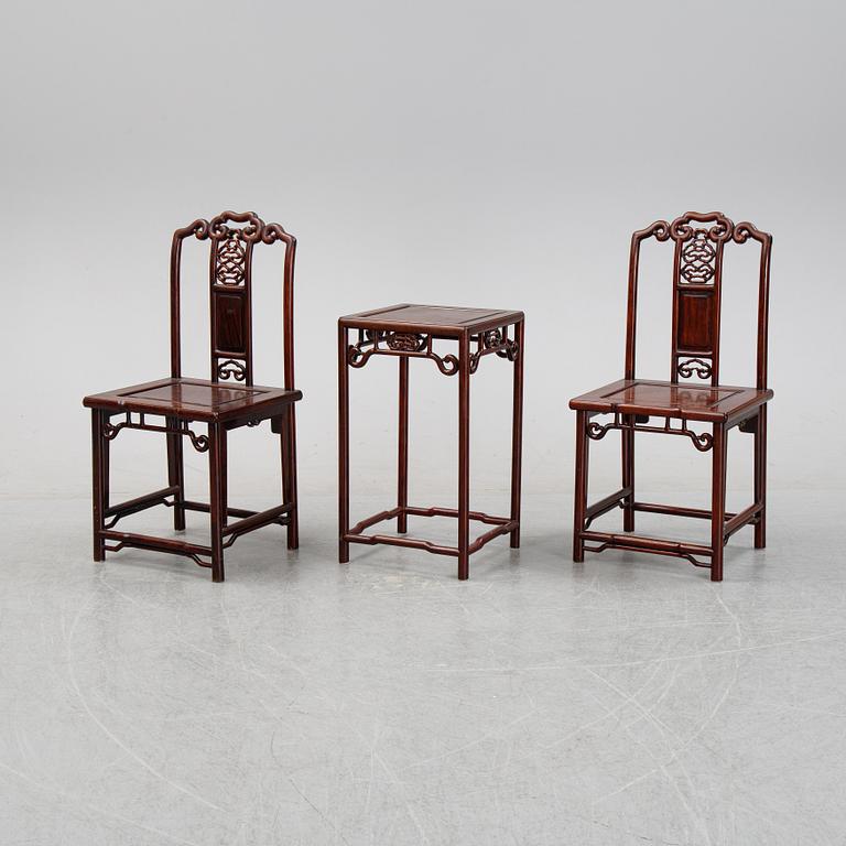 A pair of Chinese hardwood contemporary chairs and table.