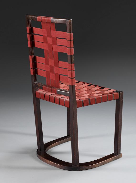 An Axel-Einar Hjorth black stained birch 'Futurum' chair with red girths by NK, Sweden,