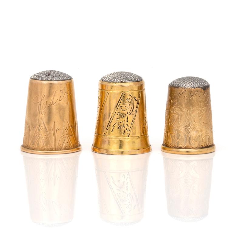 Three 18K gold thimbles.