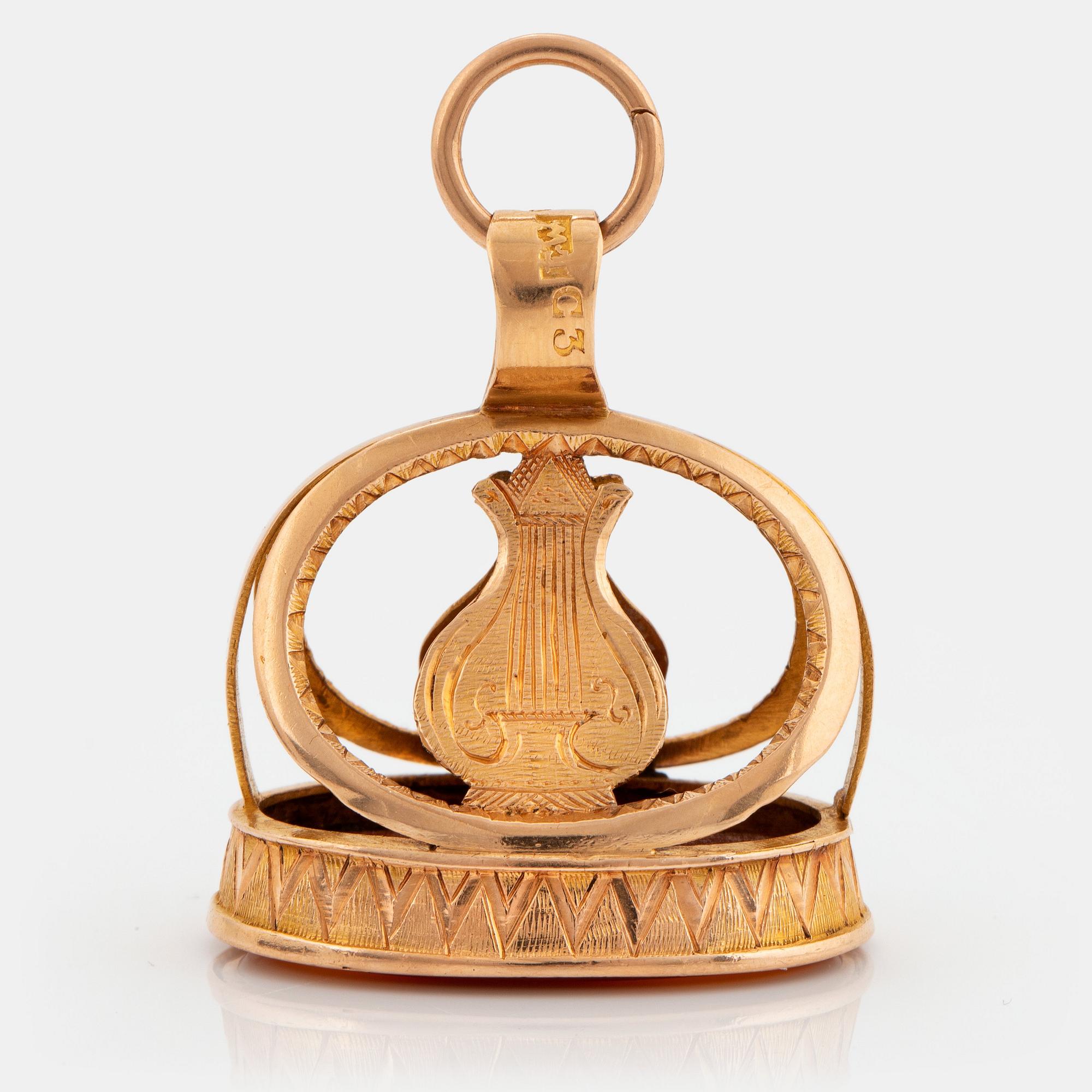 An 18K gold and carnelian seal.