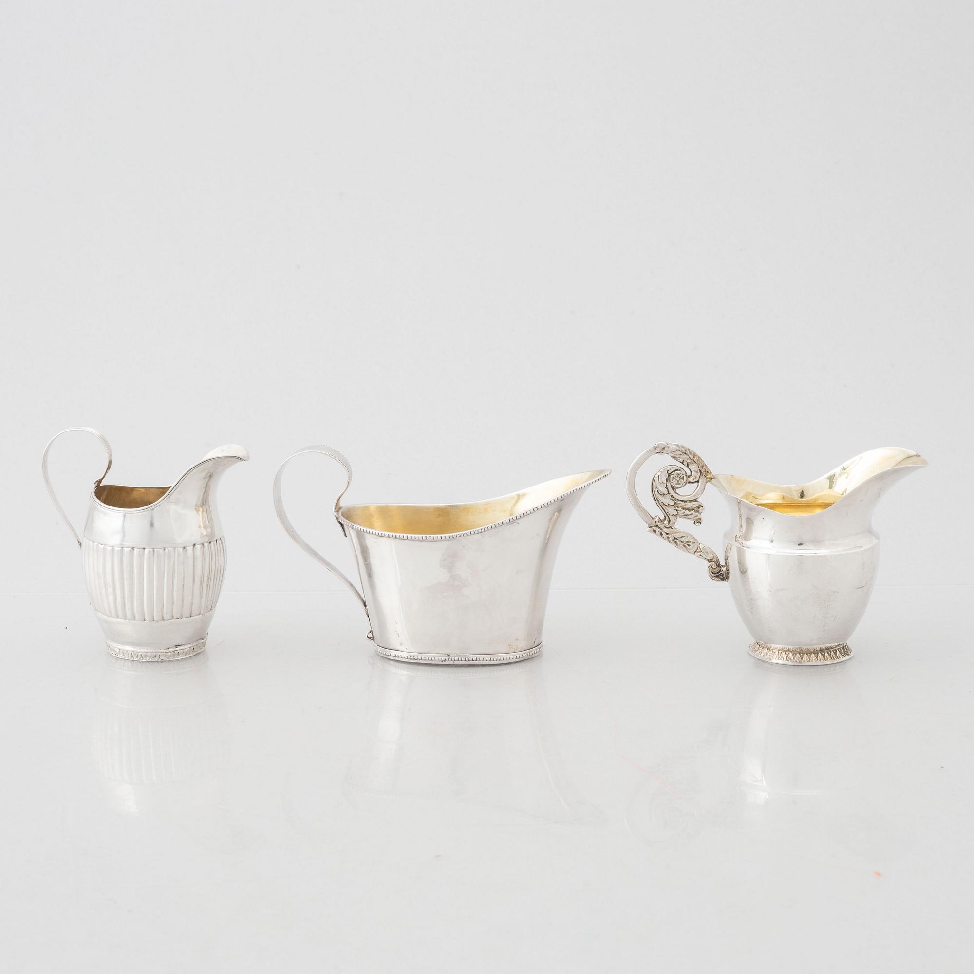 Three early 19th century Empire silver creamers,.