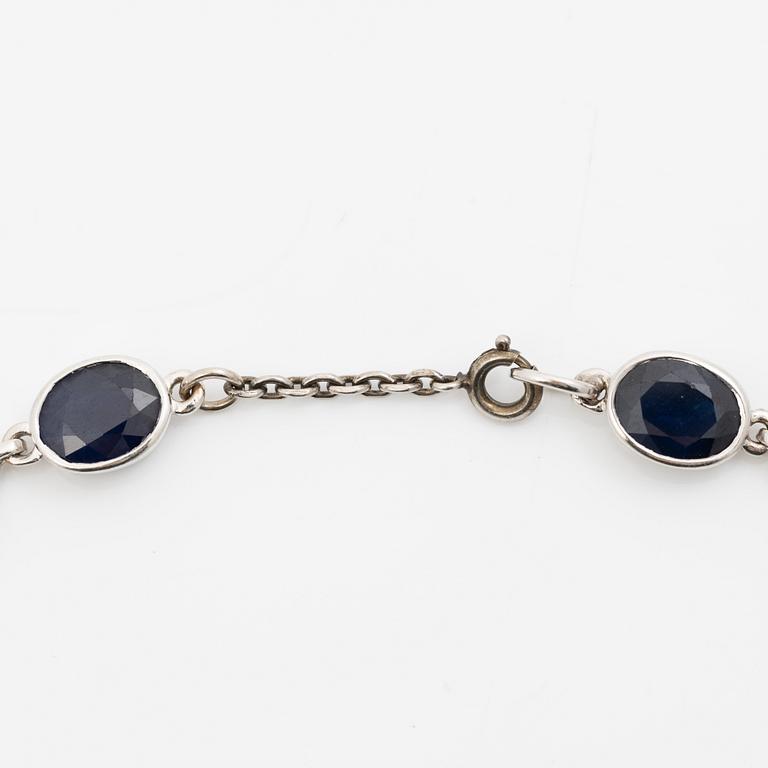 18K white gold necklace with dark sapphires.