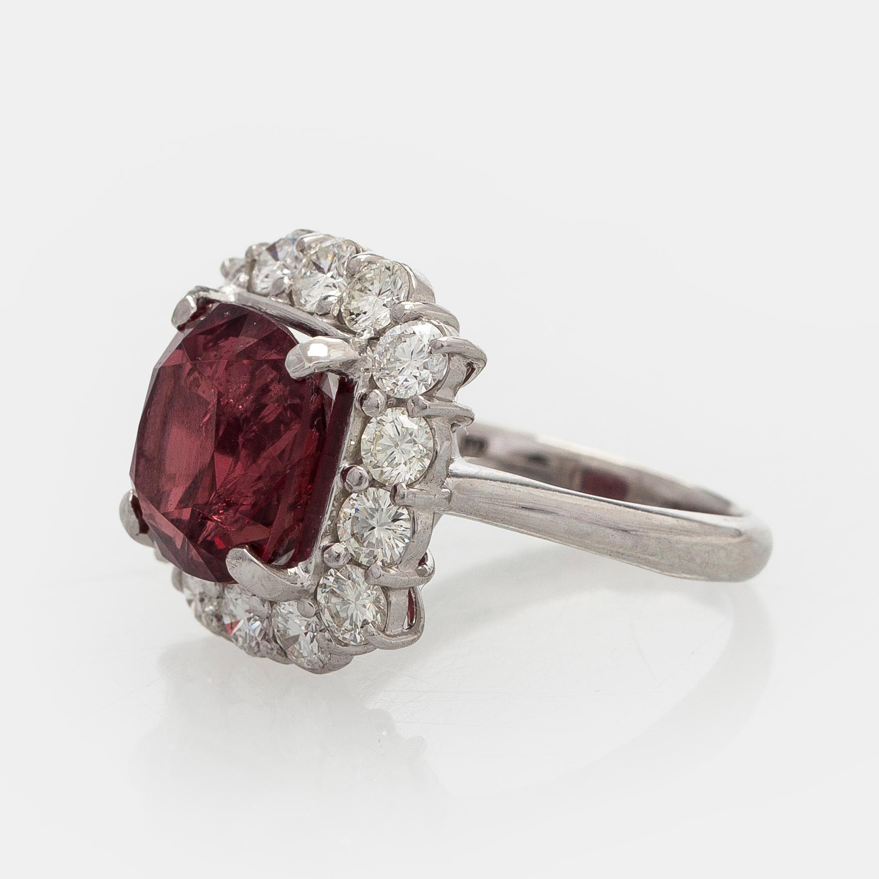 A platinum ring with spinel and brilliant cut diamonds.