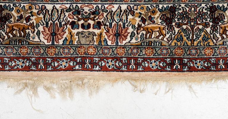 An oriental silk carpet, c. 305 x 205 cm.