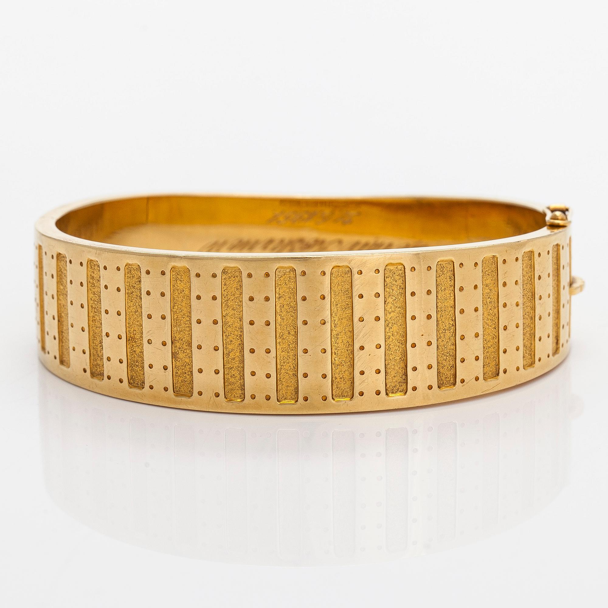 Kalevala Koru, armband, "Metsäpirtti", 18K guld. Helsingfors 1957.