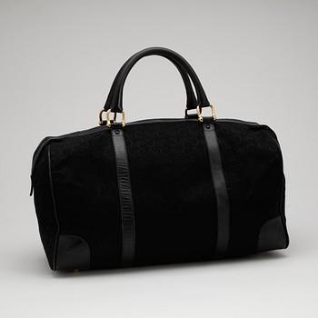 CÉLINE, a black canvas weekendbag.