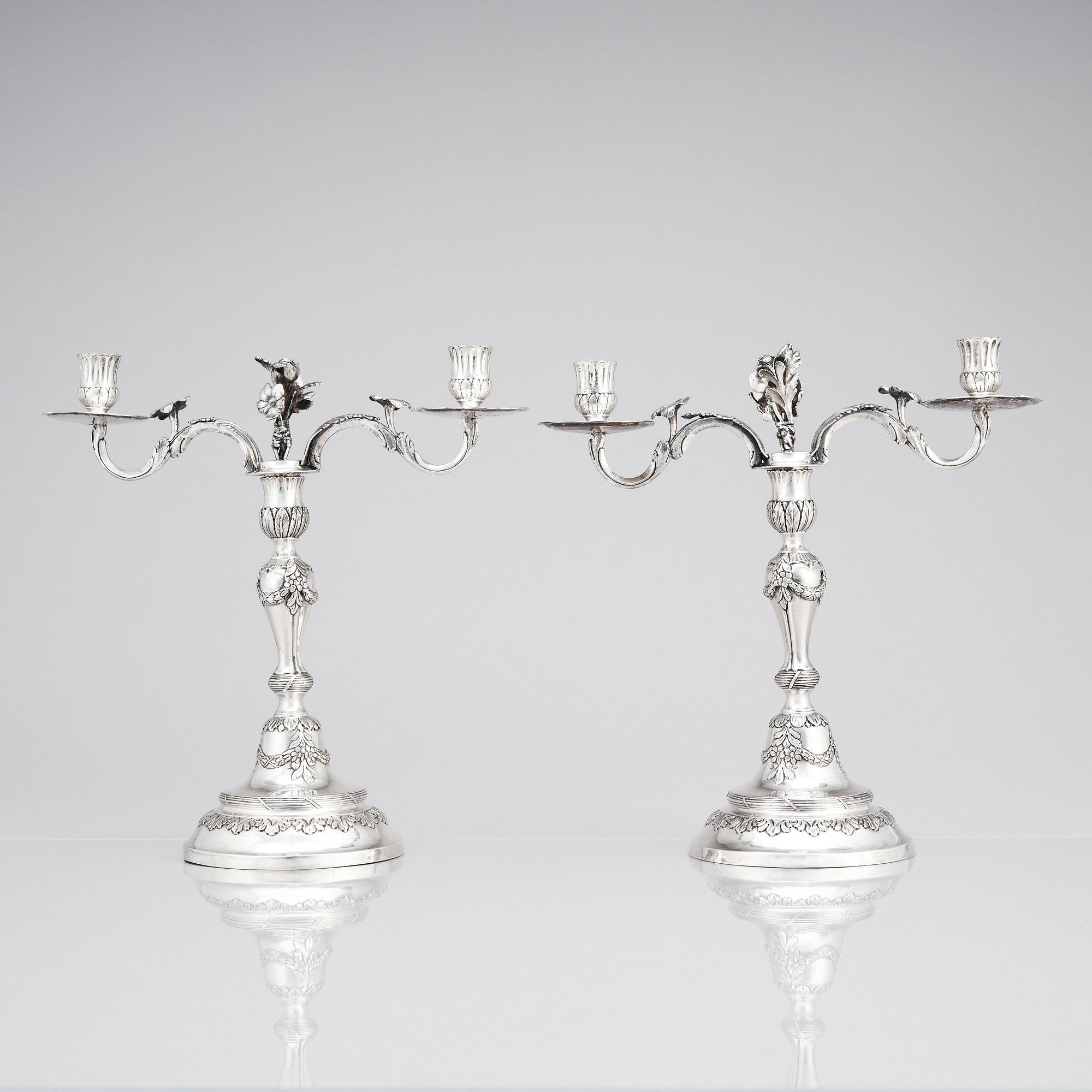 A pair of Swedish 18 century silver candelabras, mark of Lars Åkerblom Gävle 1775, arms by Christian Kullberg.