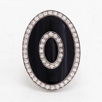 An 18K white gold ring, with diamonds totalling approximately 0.60 ct and onyx by Lanza Carlo, Italy.