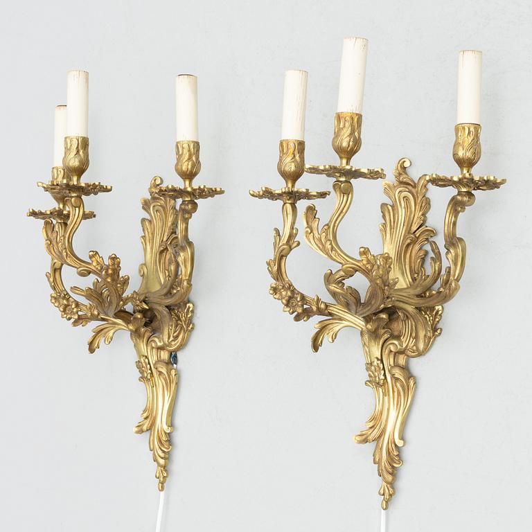 A pair of Rococo style wall lamps, early 20th Century.