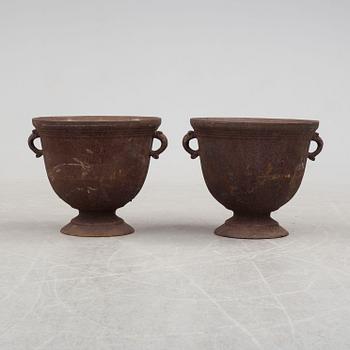 A pair of early 20th century iron garden urns.