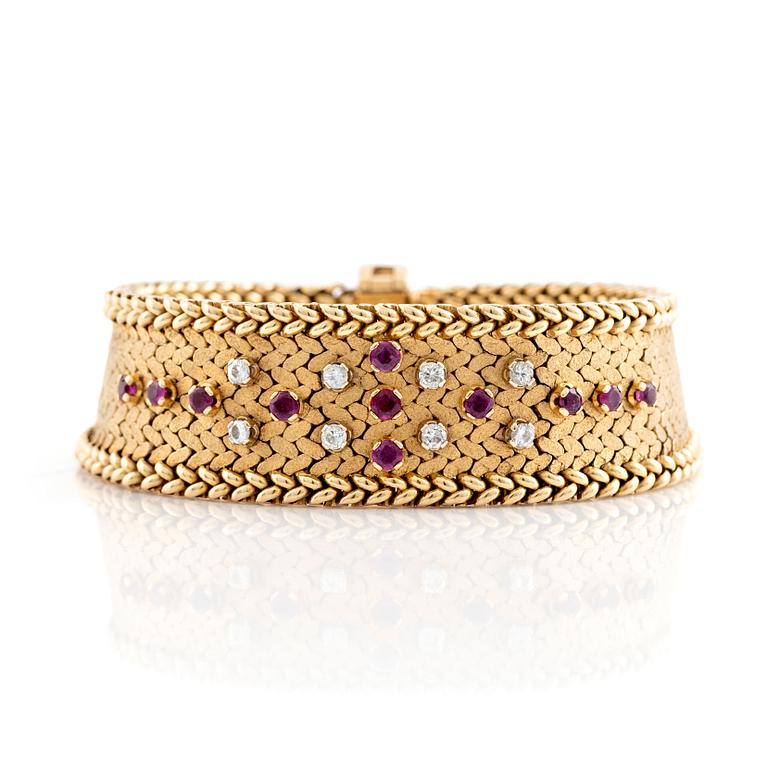 An 18K gold bracelet set with round brilliant-cut diamonds and rubies.