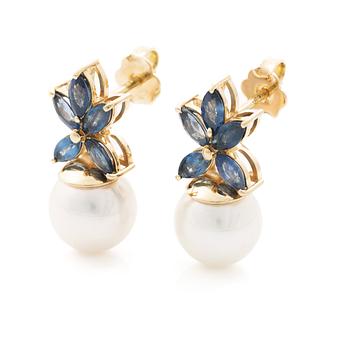 18K gold earrings with cultured Akoya pearls and navette-cut sapphires.