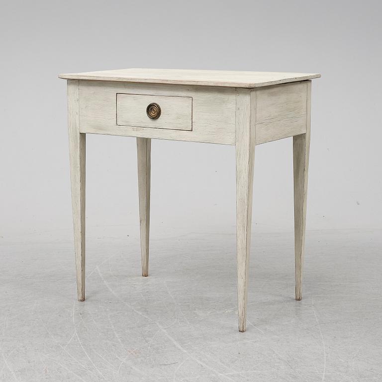 An early 19th Century painted table with a drawer.