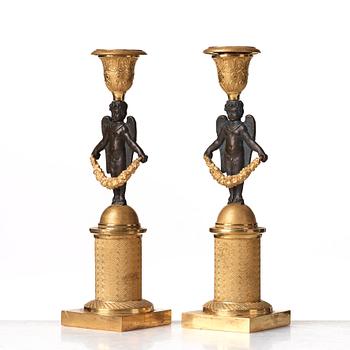 A pair of Empire early 19th century candlesticks.