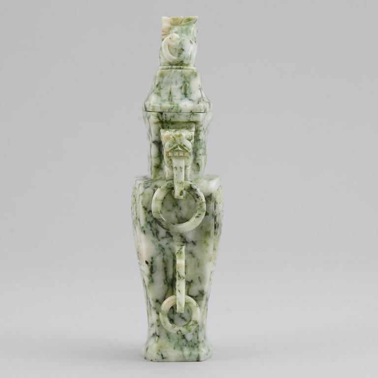 A carved green stone vase with cover, China, 20th Century.