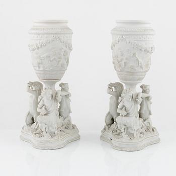 A pair of biscuit porcelain urns, owner's monogram of Oscar II of Sweden, mid 19th century.