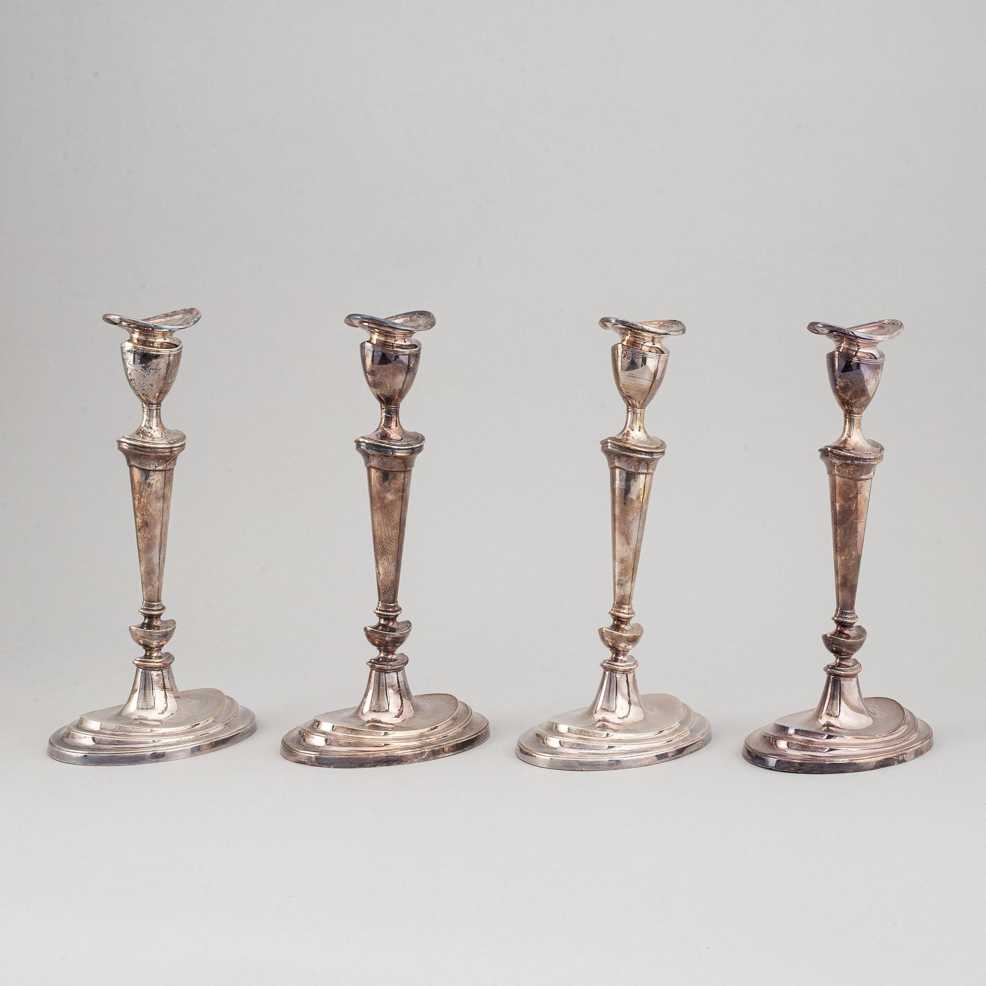 A set of four English 19th century silver-plated candlesticks.