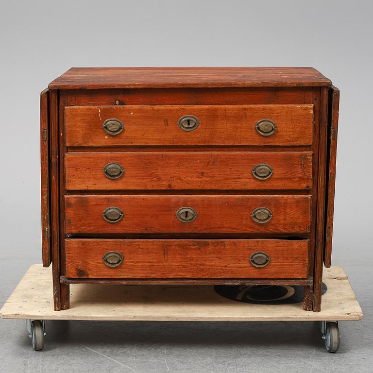 A 19th Century chest of drawers with a table top.