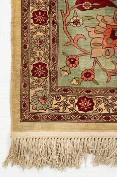 A rug, semi-antique, silke Hereke, ca 185 x 122 cm.