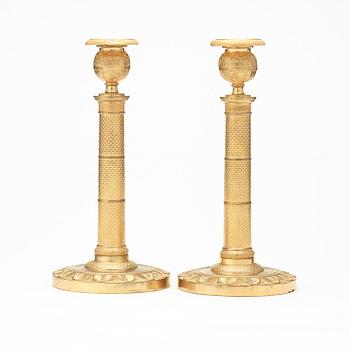 A pair of French Empire early 19th century candlesticks.