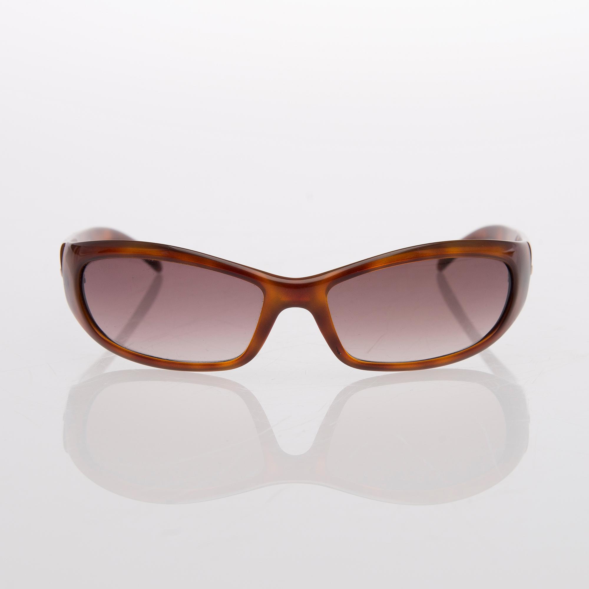 Two Pairs of Sunglasses, Prada and Chanel.