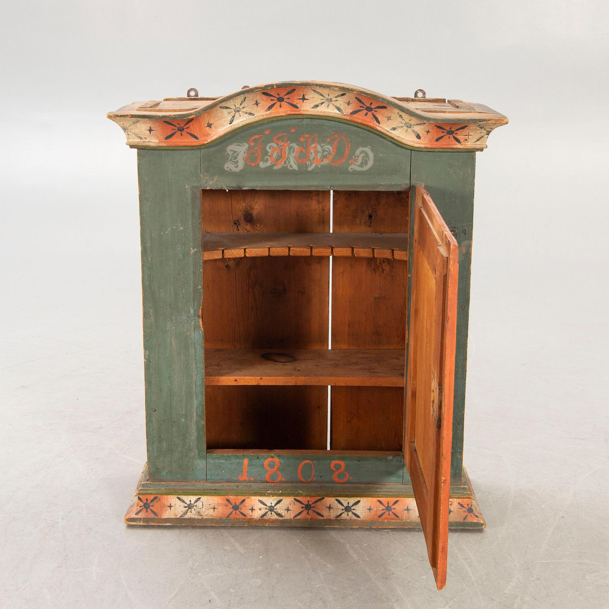 A painted Swedish wall cabinet dated 1808.