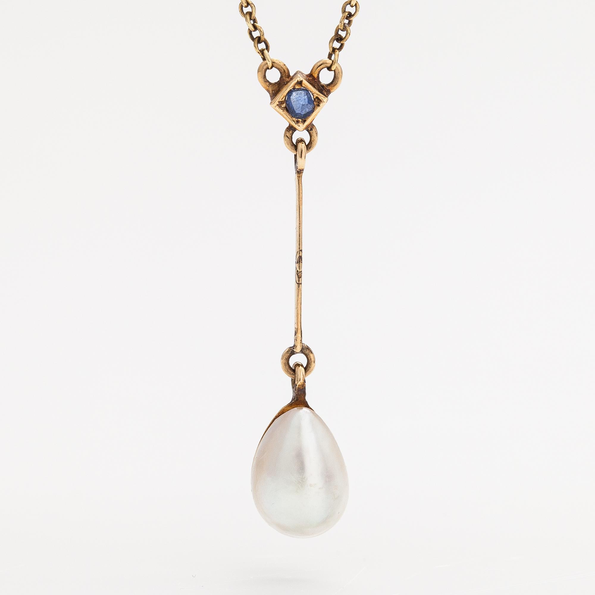 An 18K gold neckalce with a sapphire and cultured pearl.
