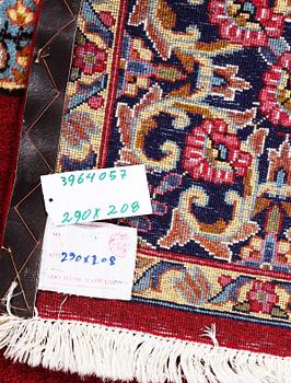 An old Kerman carpet, signed, c. 290 x 208 cm.