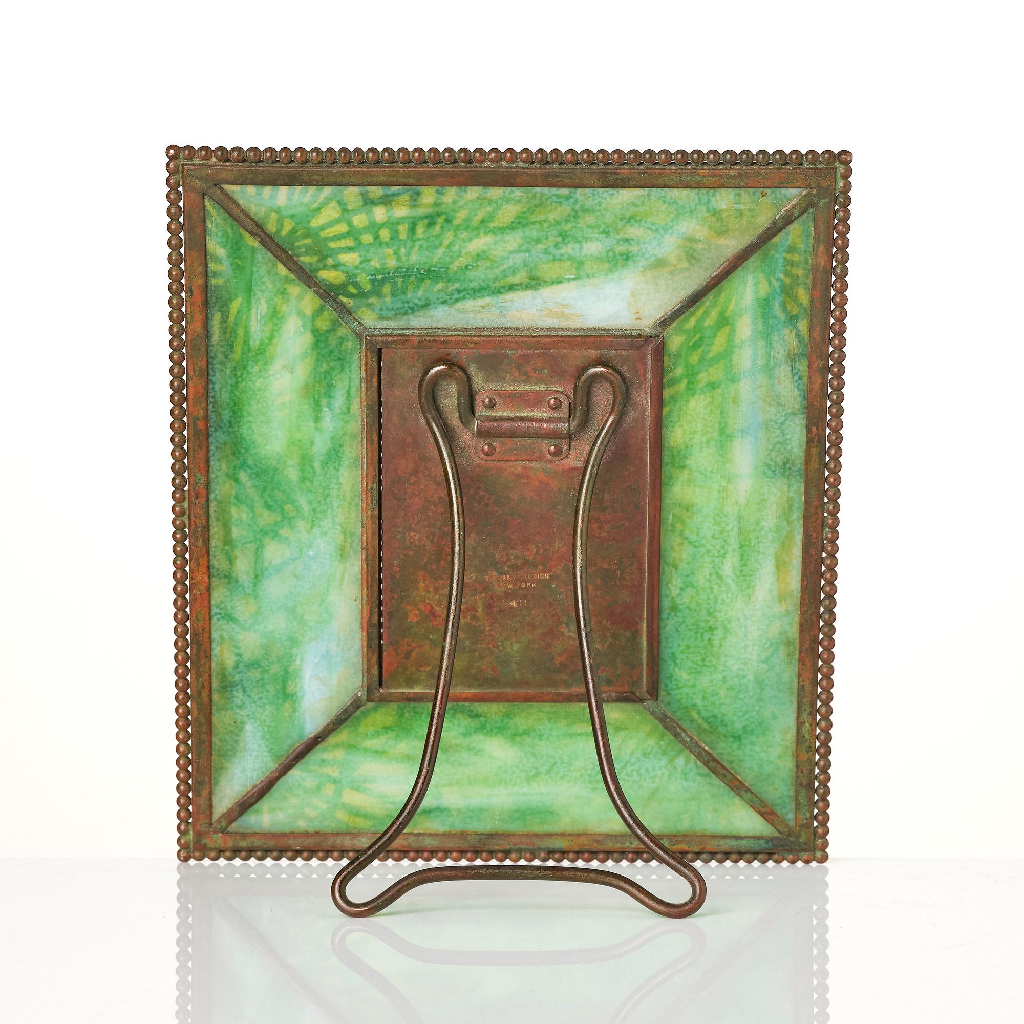 Louis Comfort Tiffany / Tiffany Studios, an Art Nouveau bronze and marbled "Pine needles" glass frame model "948", New York.
