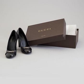 A pair of black pumps by Gucci.