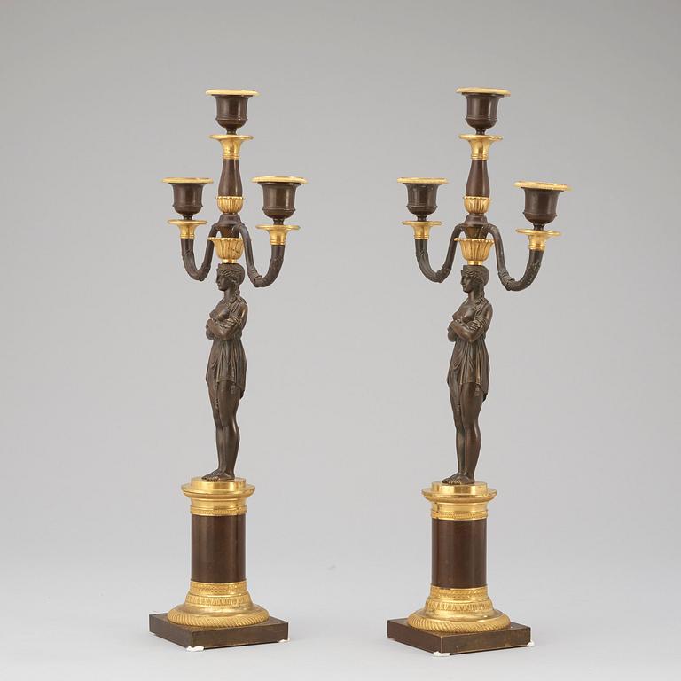 A pair of Empire early 19th century three-light candelabra.