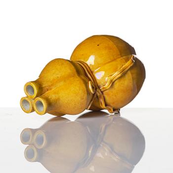 A yellow glazed triple spouted double gourd vase, Qing dynasty, 18th century.