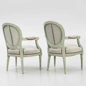 A pair of French Louis XVI open armchairs, late 18th century.