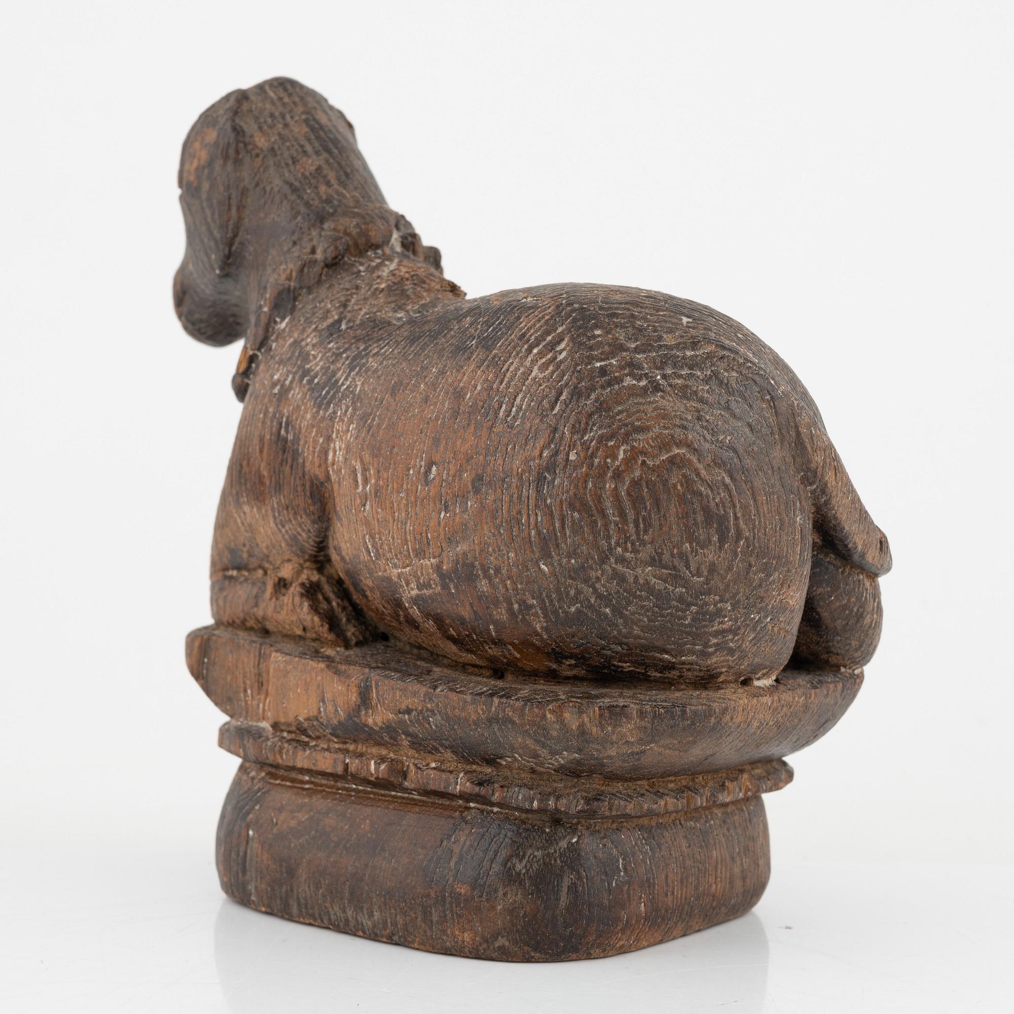 A wooden sculpture of a cow.